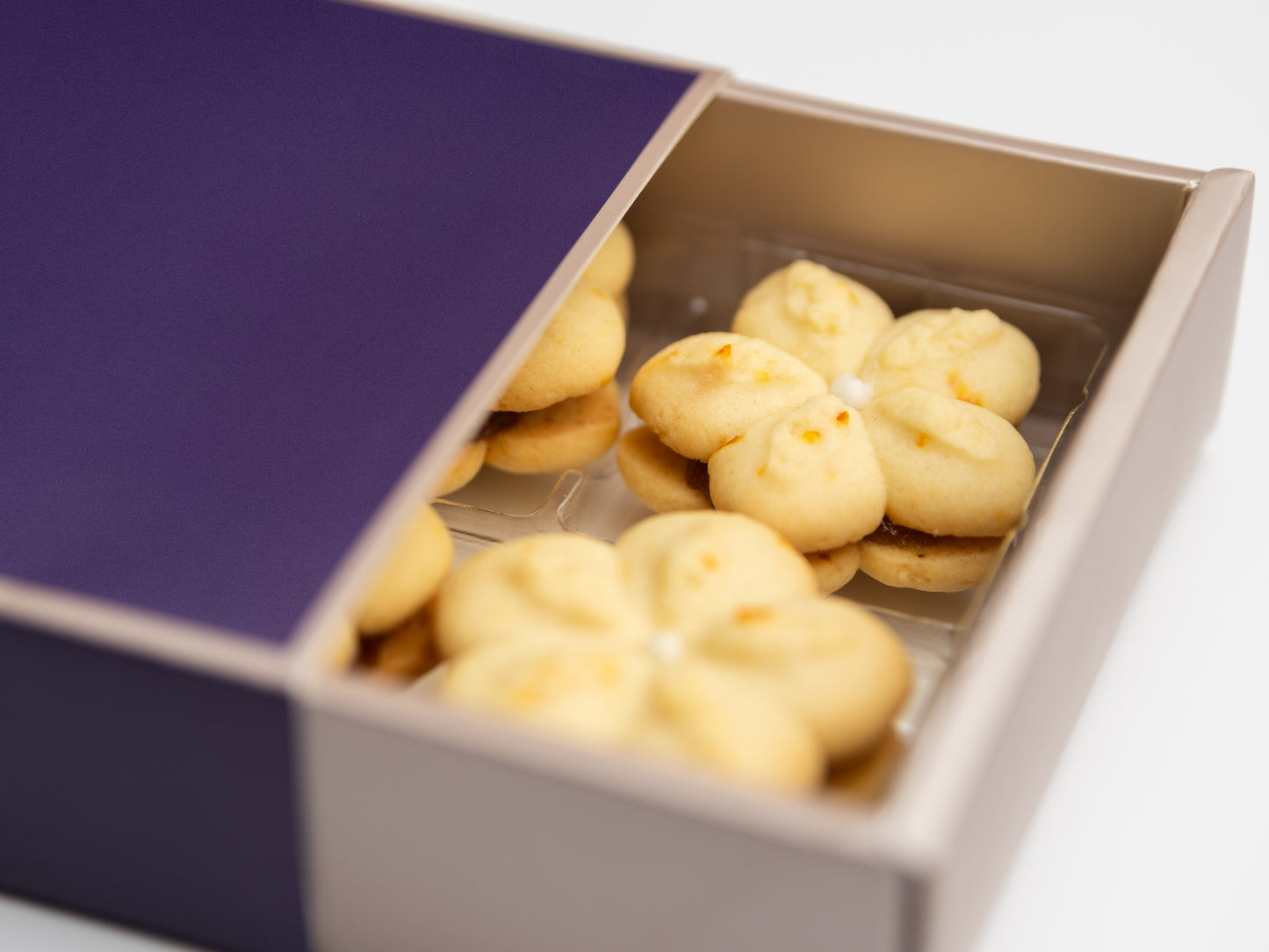 Close-up of Signature Susie K Cookies showing citrus zest flecks and glossy apricot jam center.